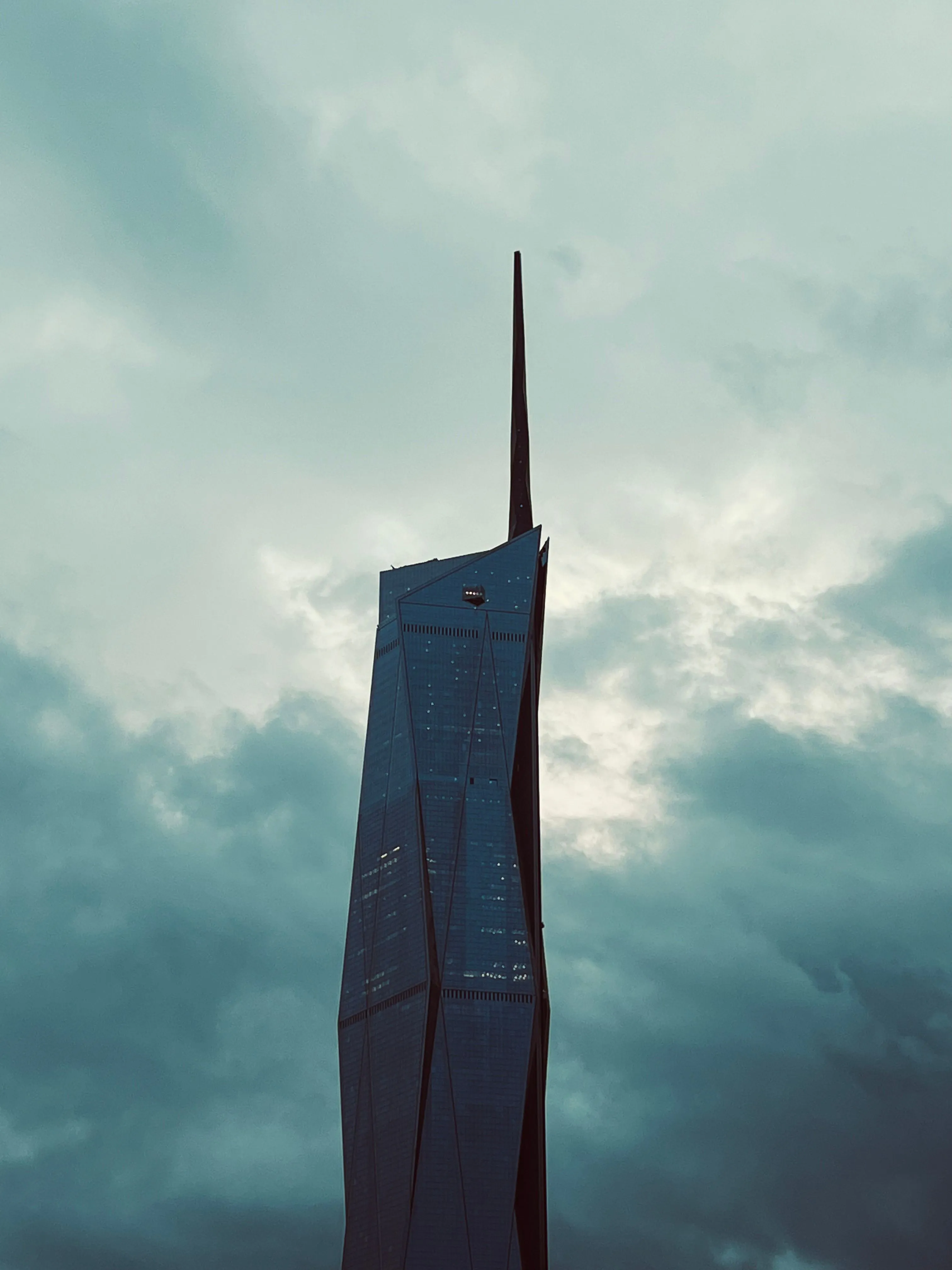 Merdeka 118 silhouetted against clouds